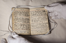 Burton diaries with gloved hands